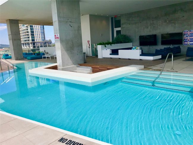 Indoor community pool featuring an outdoor living space | Image 25
