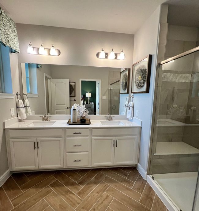 Bathroom with double vanity and a stall shower | Image 16