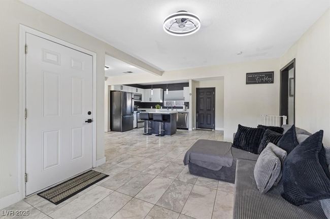 Living area with baseboards and marble finish floor | Image 8