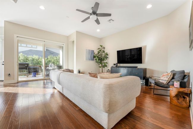 Living room featuring dark wood-style flooring, ceiling fan, and recessed lighting | Image 20