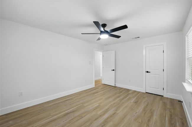 Unfurnished bedroom with light wood-style flooring, baseboards, and a ceiling fan | Image 26