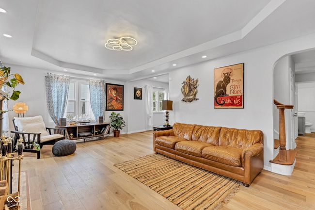 Beautiful details in the living room including arched walkways, tray ceiling, and light welcoming windows. Bring your plants! | Image 5