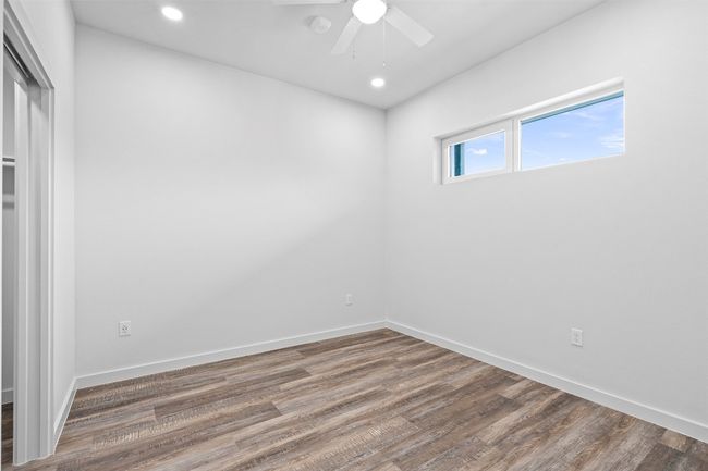 Empty room with wood finished floors, recessed lighting, and a ceiling fan | Image 14