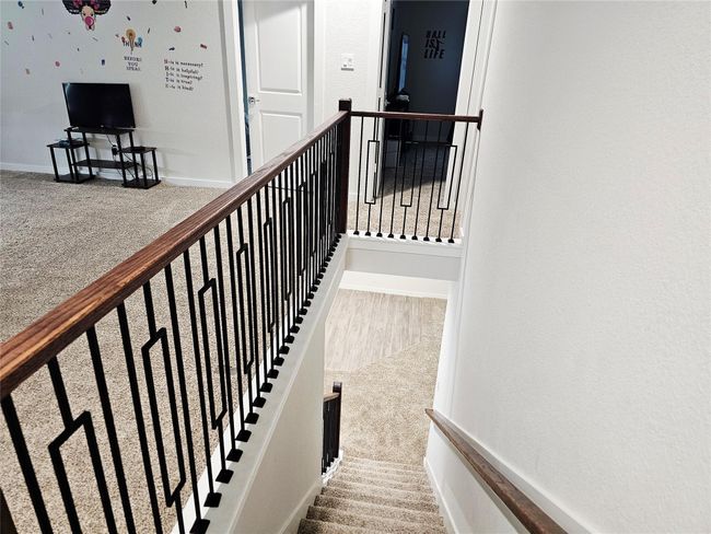 Stylist wood and iron stairwell to the second floor | Image 8
