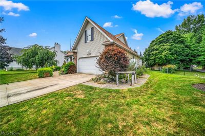 View of side of property with a garage and a lawn | Image 3