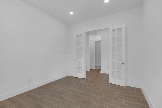 Welcome to your home office, a beautifully designed space featuring LVP flooring and French doors that seamlessly blends style and functionality. | Image 7
