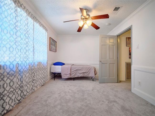 This upstairs bedroom overlooks the pool below. | Image 30