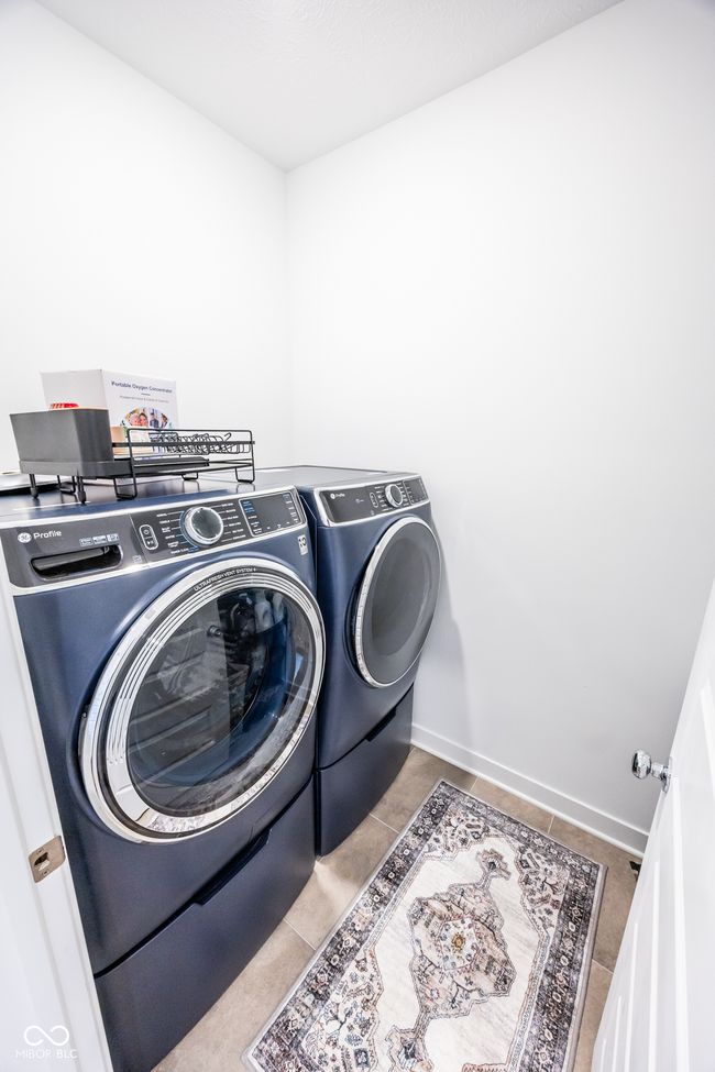 washroom with independent washer and dryer and tile patterned flooring | Image 17