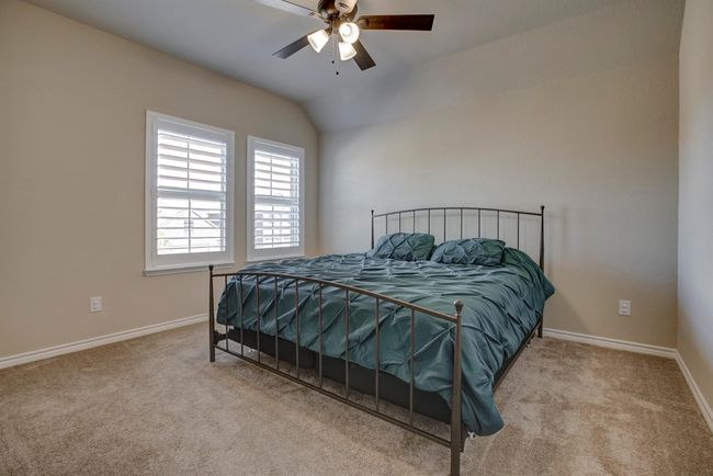 Carpeted bedroom with vaulted ceiling and ceiling fan | Image 30