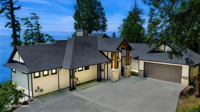 View of front facade with driveway, roof with shingles, a chimney, a garage, and stone siding | Image 93
