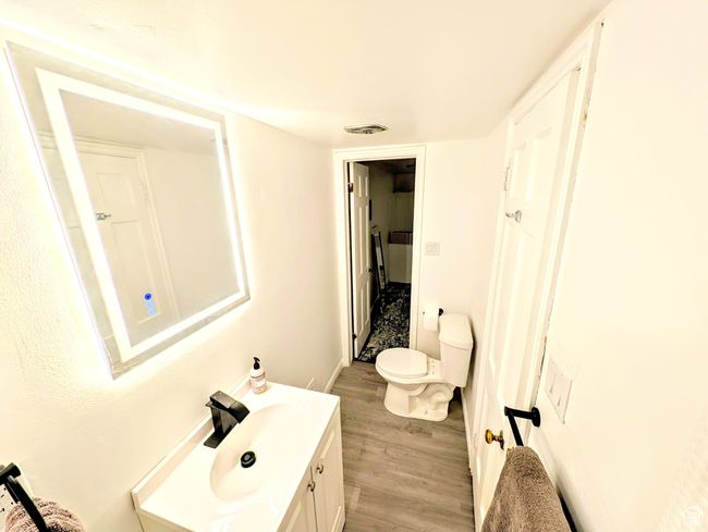 Bathroom with wood finished floors and vanity | Image 4