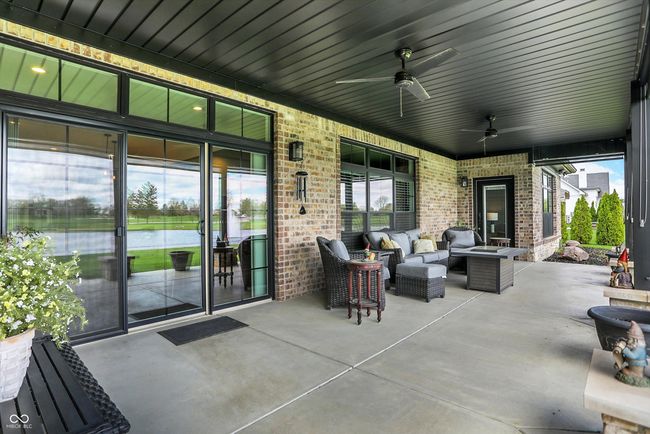 view of patio / terrace with ceiling fan, an outdoor hangout area, and a water view | Image 39