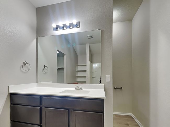 Full bathroom with wood finished floors, vanity, and a spacious closet | Image 10