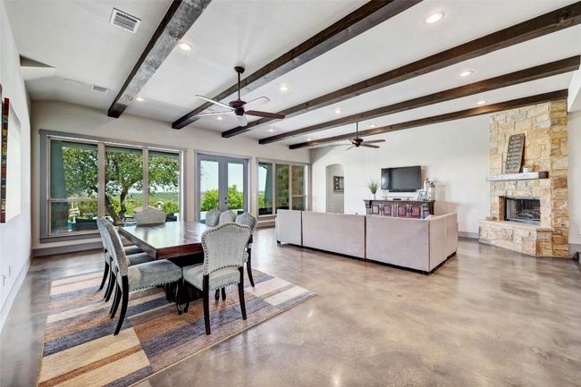 Light and bright! Tons of natural light pours in through the wall of windows that overlooks the pool, hill country, and outdoor living. | Image 4