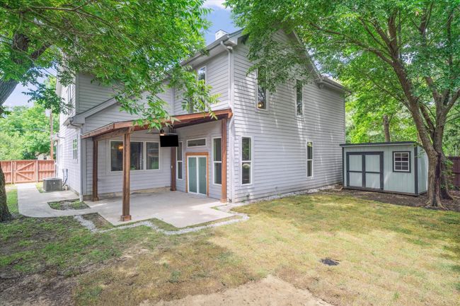 Back of property with a patio area, central air condition unit, and a chimney | Image 36