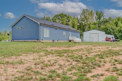 View of yard with a garage and an outbuilding | Image 3