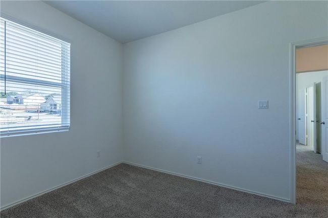Carpeted empty room featuring baseboards | Image 26