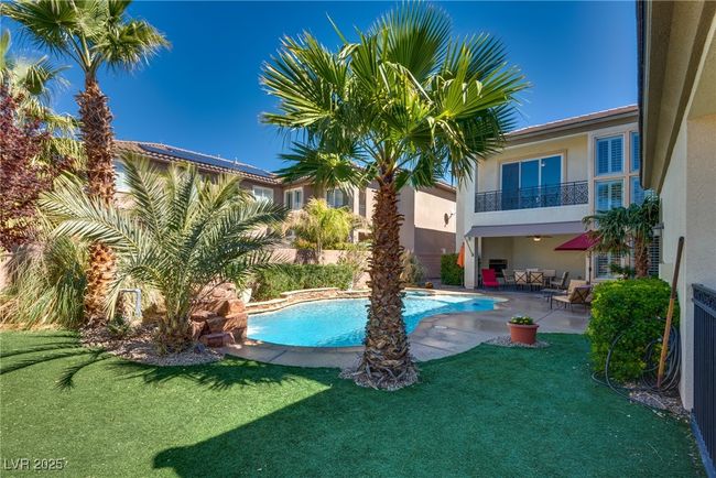 View of pool with a fenced in pool, a patio, and a yard | Image 68