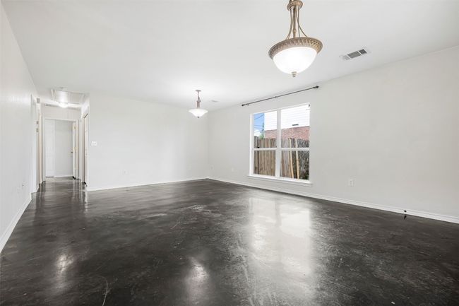 Spare room with attic access and finished concrete floors | Image 9