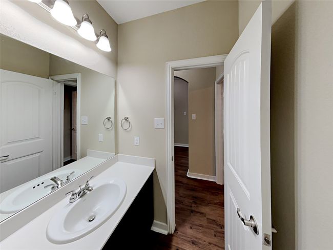 Bathroom with wood finished floors and vanity | Image 6
