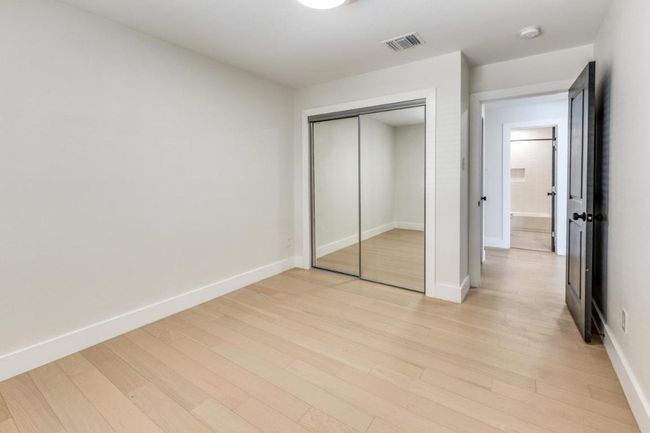 Unfurnished bedroom with baseboards, visible vents, a closet, and light wood-style flooring | Image 16