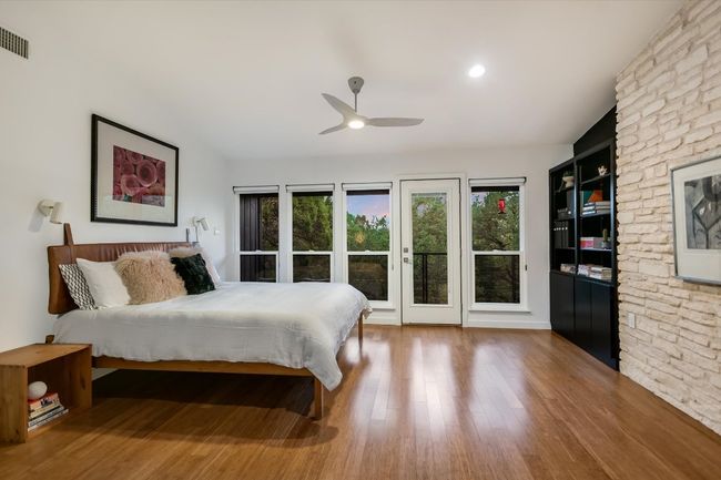 Bedroom featuring limestone wall and seating area | Image 15