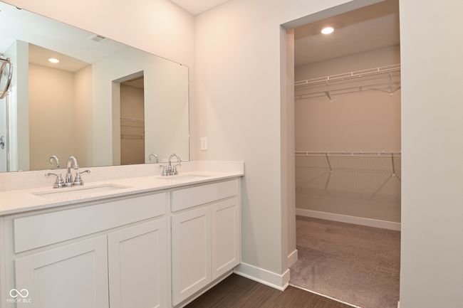 full bath with a sink, a spacious closet, double vanity, and baseboards | Image 42