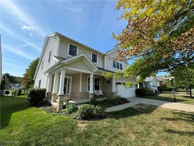 View of front of house with a front yard, a garage, and covered porch | Image 2