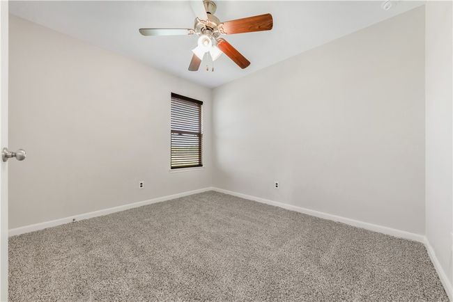 Carpeted empty room featuring baseboards and ceiling fan | Image 13