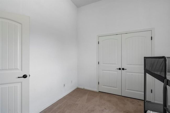 Unfurnished bedroom featuring carpet, a closet, and baseboards | Image 29