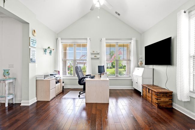 Office area featuring a ceiling fan, dark wood-style floors, and lofted ceiling | Image 7