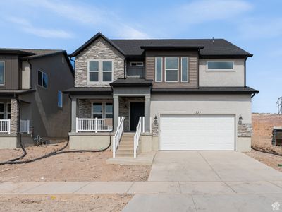 View of front facade featuring a porch and a garage | Image 1