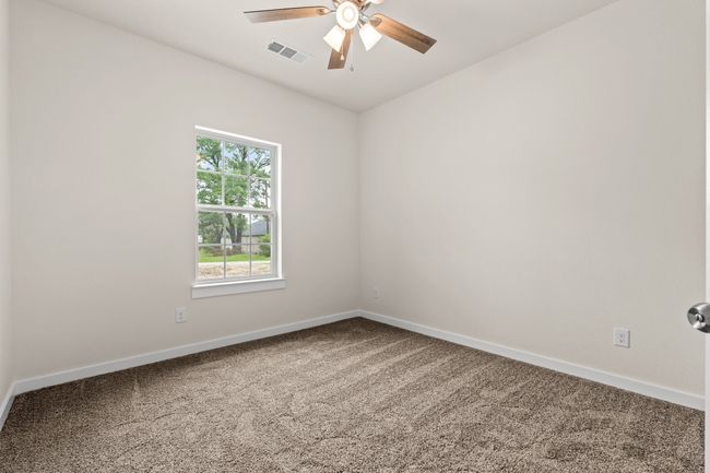 Spare room featuring carpet, a ceiling fan, and baseboards | Image 9