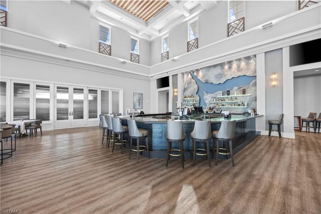Kitchen featuring beam ceiling, a kitchen breakfast bar, coffered ceiling, and wood finished floors | Image 36