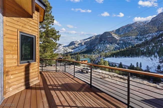 Snow covered deck featuring a mountain view | Image 15