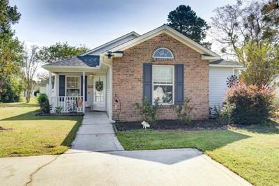 Bungalow with a front yard and a porch | Image 1