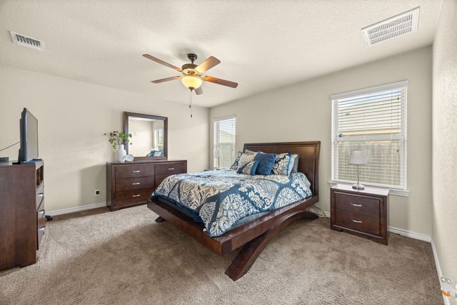 Carpeted bedroom with a ceiling fan and baseboards | Image 15