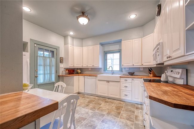 Updated kitchen with butcher block countertops and plenty of cabinetry! | Image 13