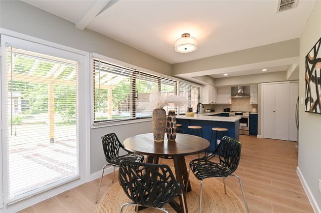 Dining space featuring light wood-style flooring and recessed lighting | Image 8