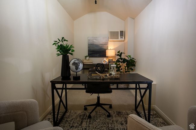 Office area featuring a wall mounted air conditioner, baseboards, and lofted ceiling | Image 18