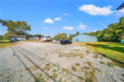 View of all of the buildings on property. From Left to Right: 28x28 Garage, House, 12x16 Office, 60x80 Outbuilding Shop | Image 2