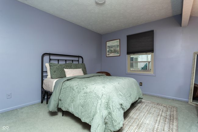 carpeted bedroom featuring a textured ceiling | Image 19