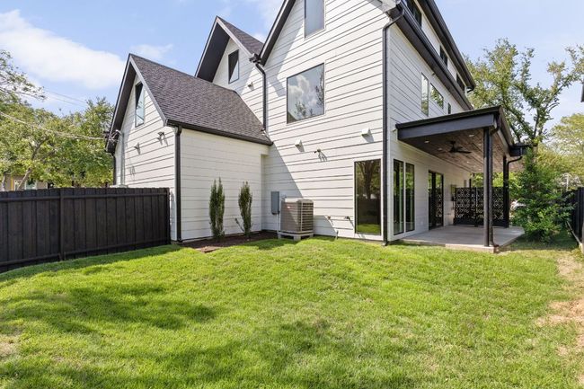 Rear view of house featuring a ceiling fan, a patio, a fenced backyard, and roof with shingles | Image 35
