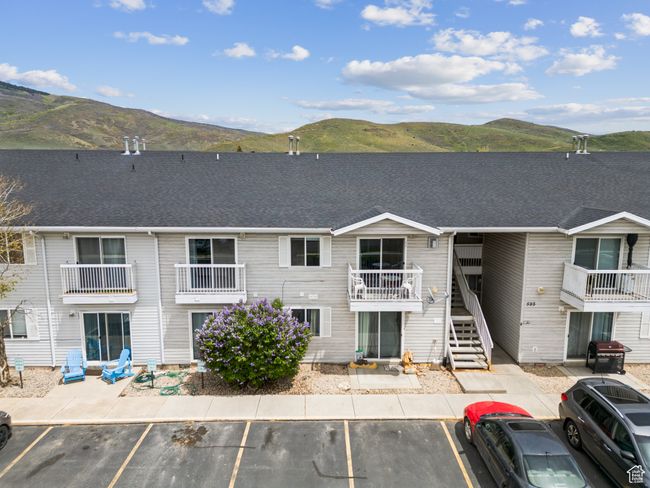 View of building exterior featuring a mountain view, uncovered parking, and stairway | Image 28