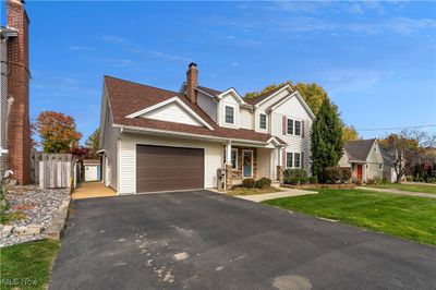 View of front of home with a front lawn and a garage | Image 2