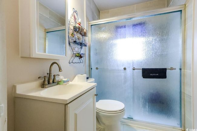 Bathroom featuring a stall shower, vanity, and toilet | Image 29