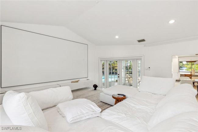 Cinema with vaulted ceiling, french doors, recessed lighting, and visible vents | Image 15