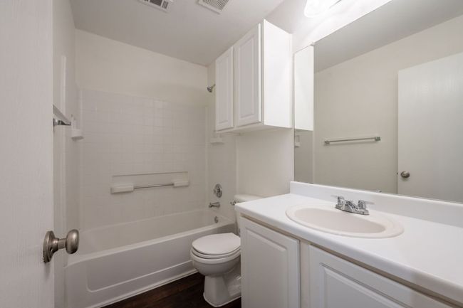 Full bath with toilet, wood finished floors, vanity, and shower / bathtub combination | Image 25