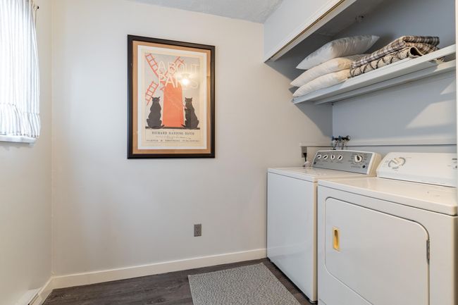Laundry room with baseboards, dark wood-type flooring, and washing machine and dryer | Image 13