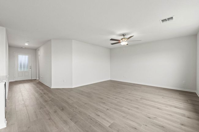 Spare room featuring ceiling fan and light wood-style floors | Image 5
